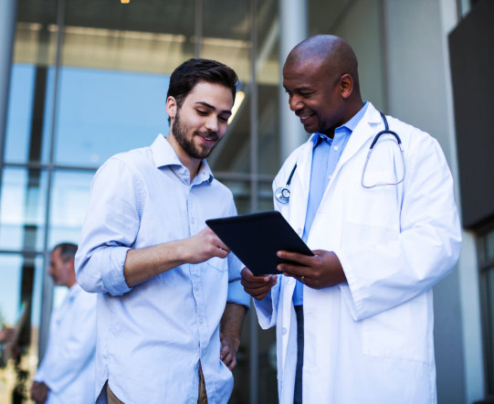 man and doctor smiling