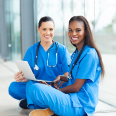 two healthcare staff smiling