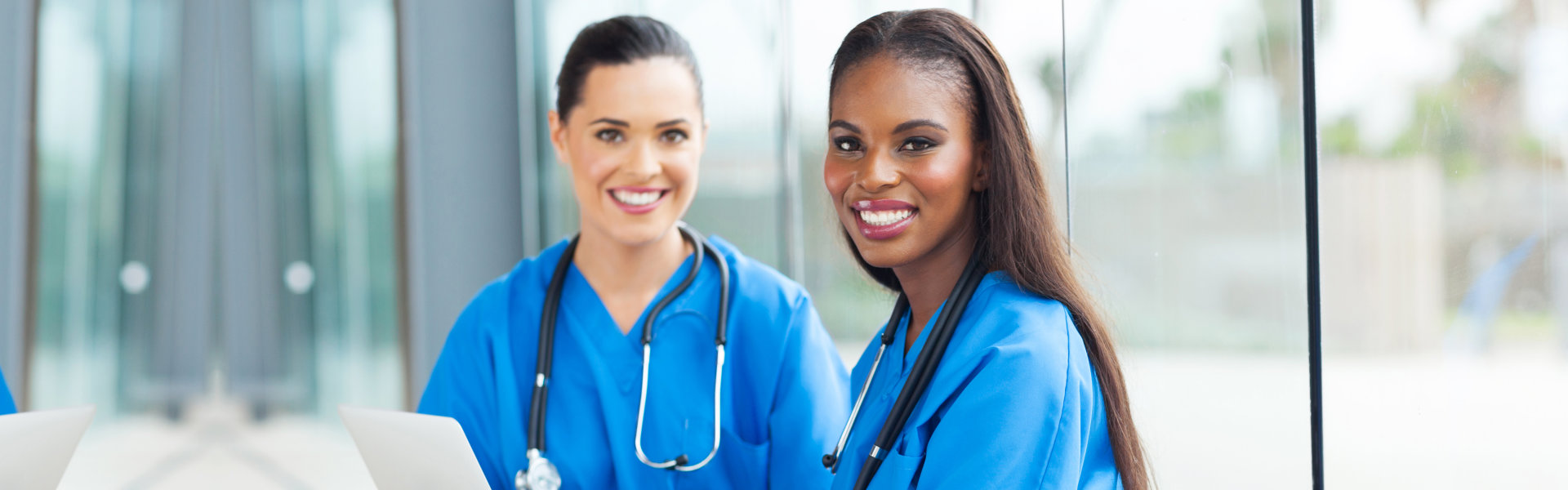 two healthcare staff smiling