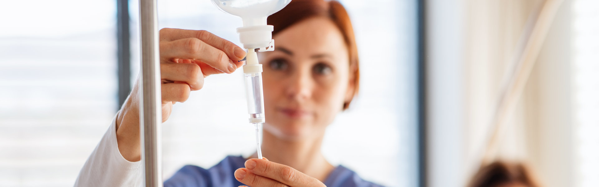 A female healthcare staff adjusting a dextrose